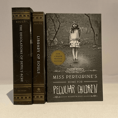 The covers of Miss Peregrine's Home for Peculaiar Children, Library of Souls, The Desolations of Devil's Acre by Ransom Riggs.